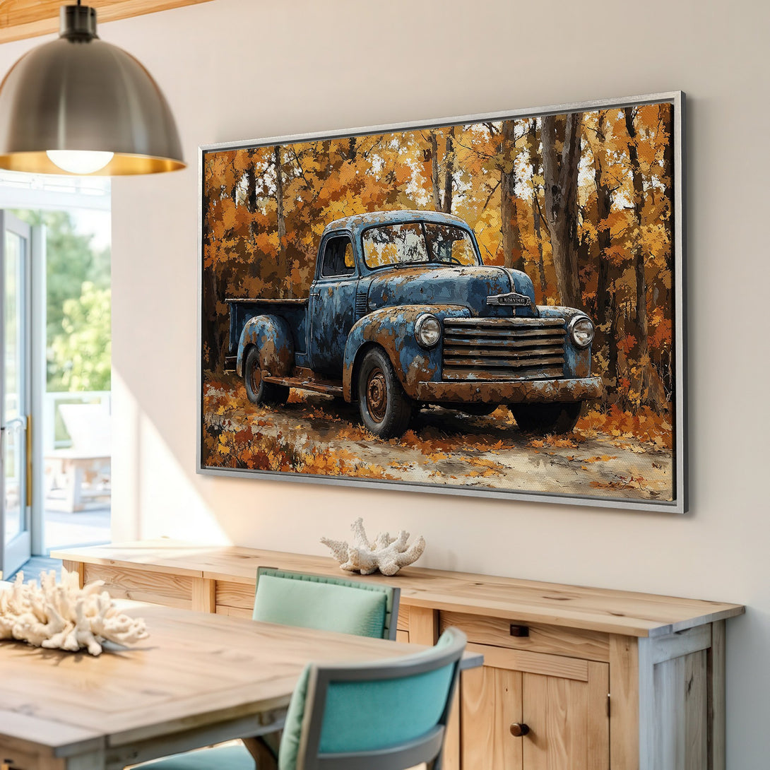 Framed Wall Art featuring a vintage blue truck in an autumn forest. Rustic style with warm orange and blue color palette. Perfect for home decor!