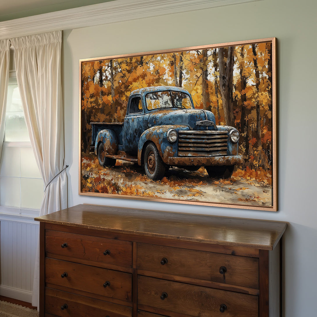 Framed Wall Art: Rustic blue truck canvas print with fall foliage. Warm, inviting color palette. Perfect for farmhouse decor.