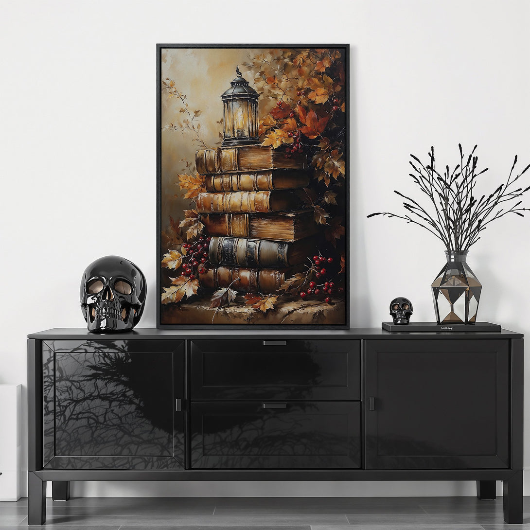 Framed Wall Art featuring a stack of books with a lantern and autumn leaves in warm, earthy tones. Perfect for adding a touch of cozy elegance to your home.