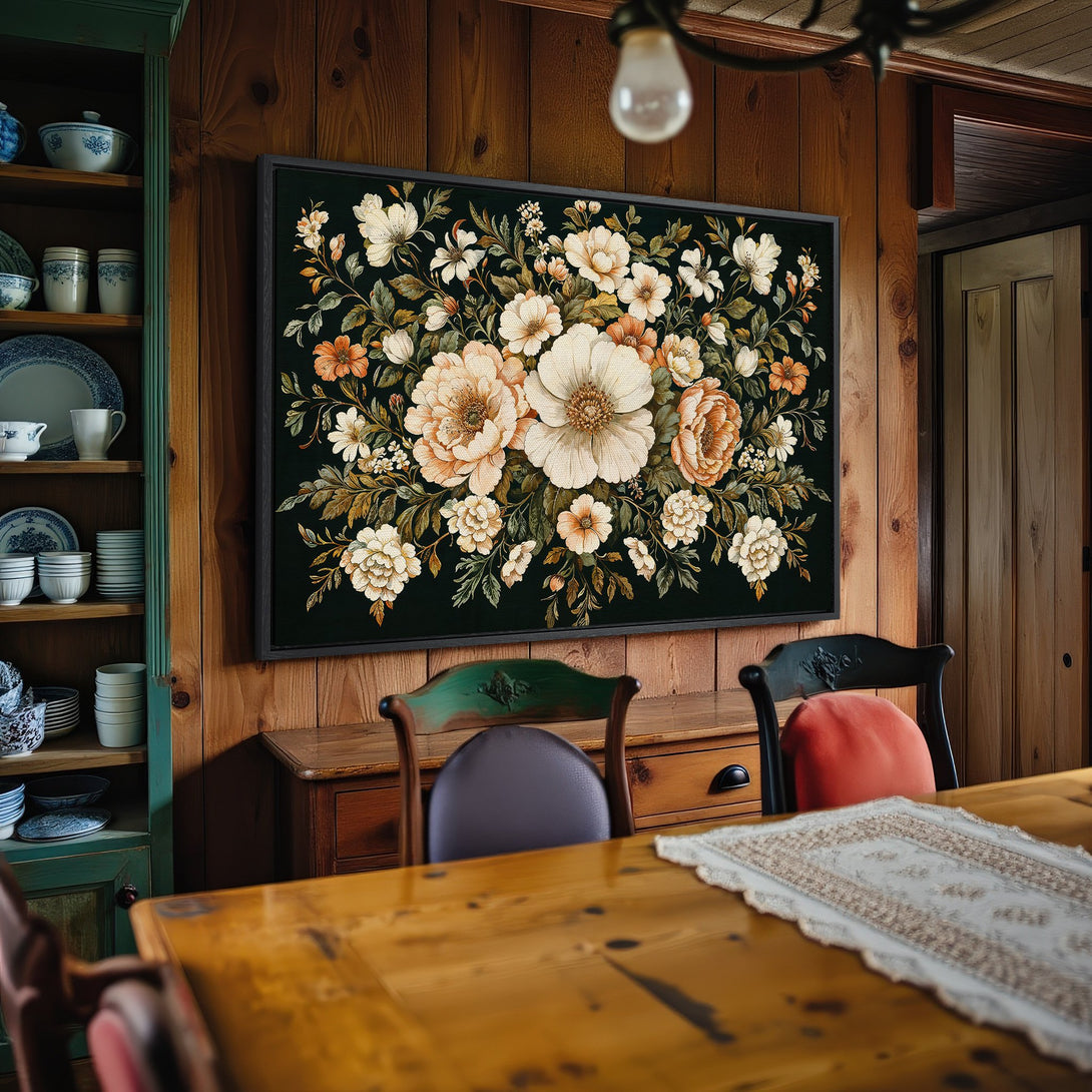 Framed Wall Art: Floral canvas print in a rustic dining room. Features a dark background with cream and orange flowers. Adds warmth and elegance to any space.