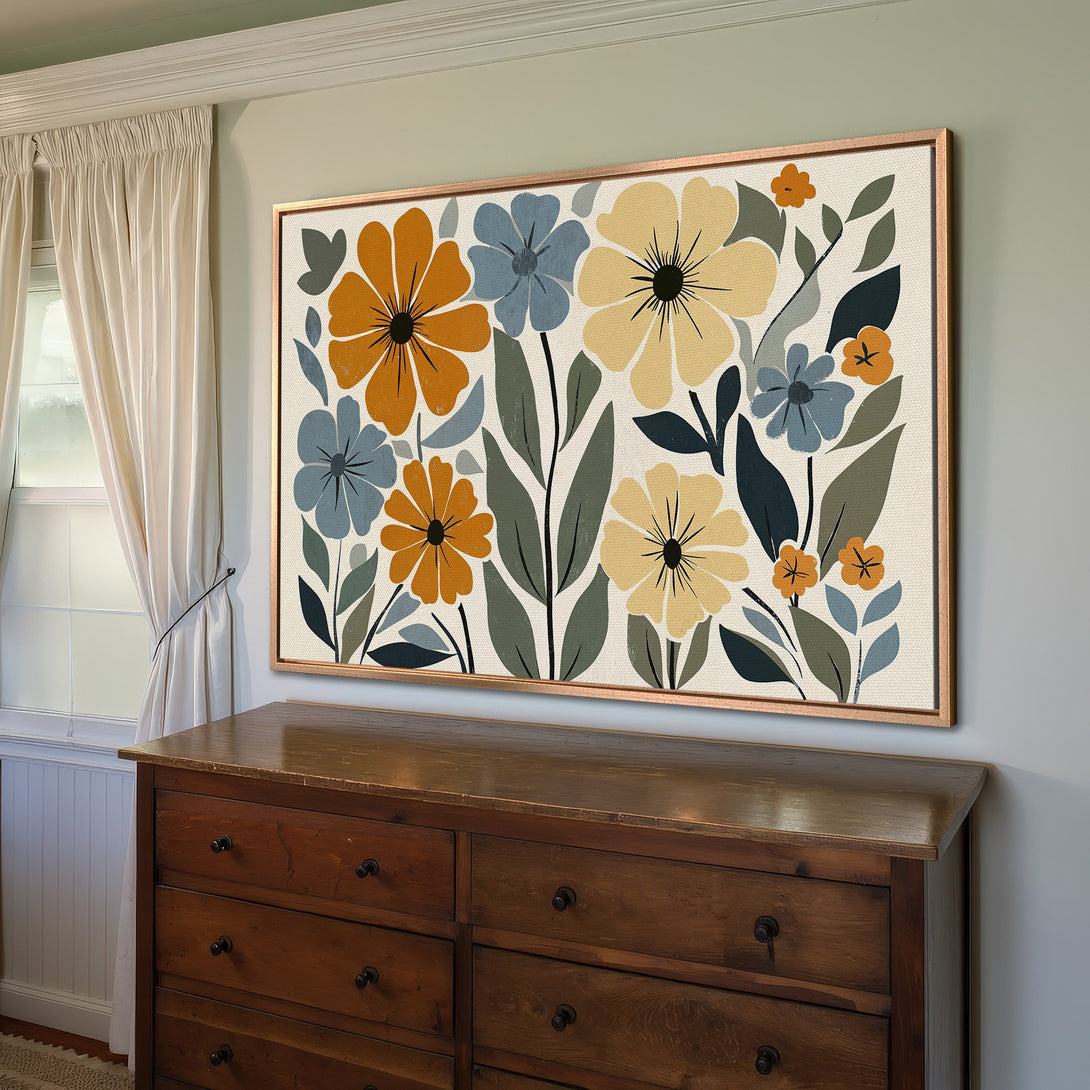 Framed Wall Art featuring a floral design in a mid-century modern style. Warm, earthy color palette with orange, blue, and yellow blooms.