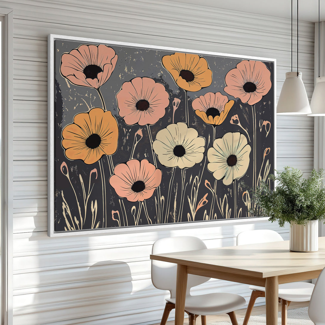 Framed Wall Art featuring stylized poppy flowers in a modern, botanical style. Warm peach, gold, and cream hues pop against a dark gray background.