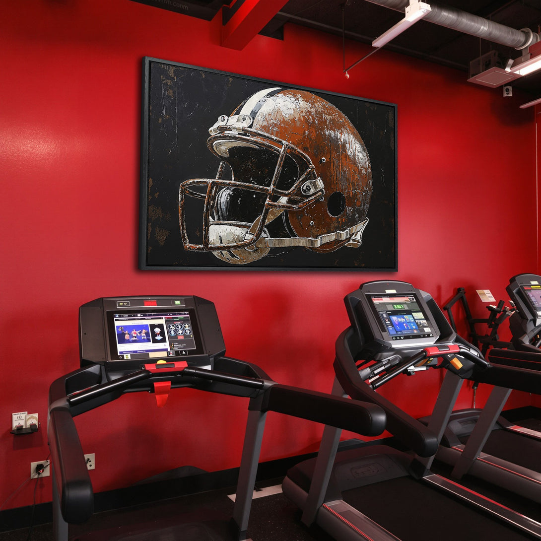Framed Wall Art: Football helmet canvas print in a gym, featuring a distressed style and a bold red and brown color palette. Perfect for sports fans!