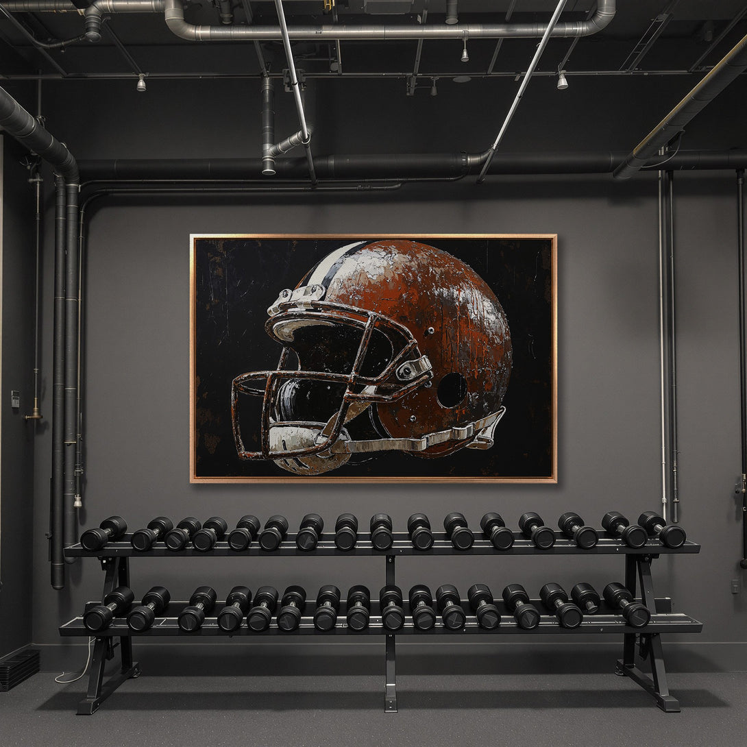 Framed Wall Art: Rustic football helmet canvas print in a modern gym. Warm brown and black color palette, industrial style. Perfect for sports fans.