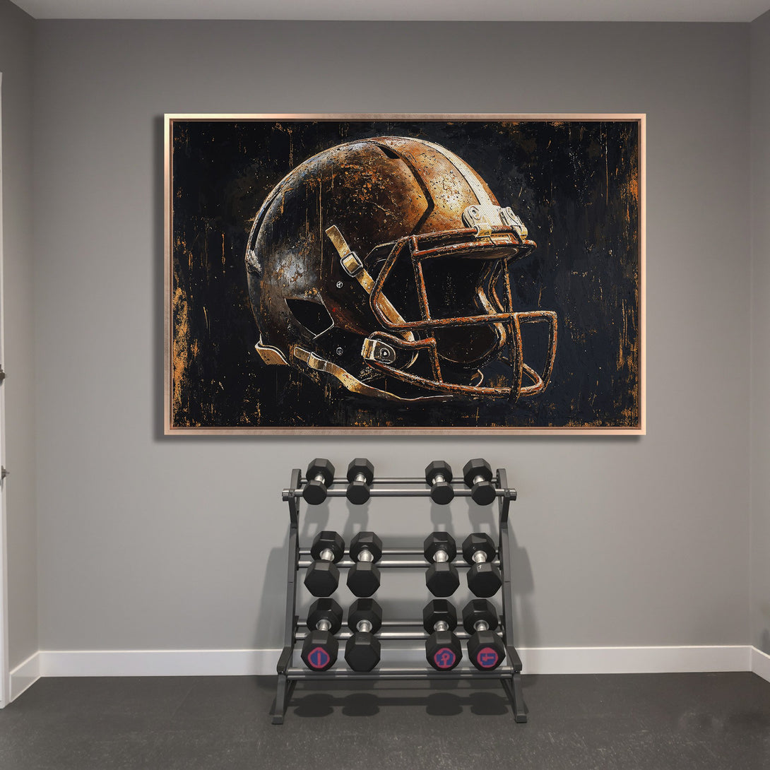 Framed Wall Art: Rustic football helmet canvas print in a modern gym. Features a distressed style with a black and gold color palette.