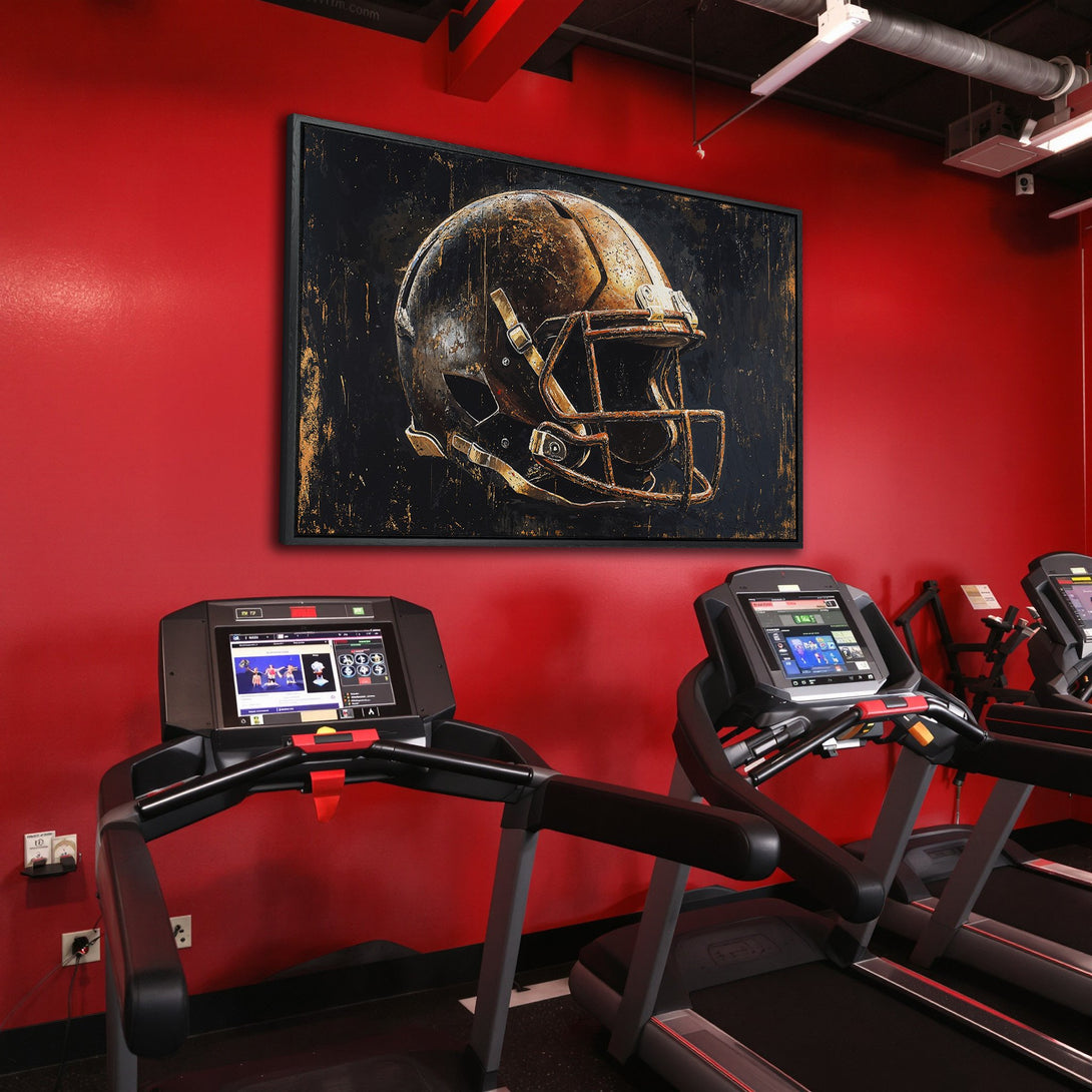 Framed Wall Art: Abstract football helmet art in gold and black, displayed in a red gym setting. Elevate your space with this unique canvas print!