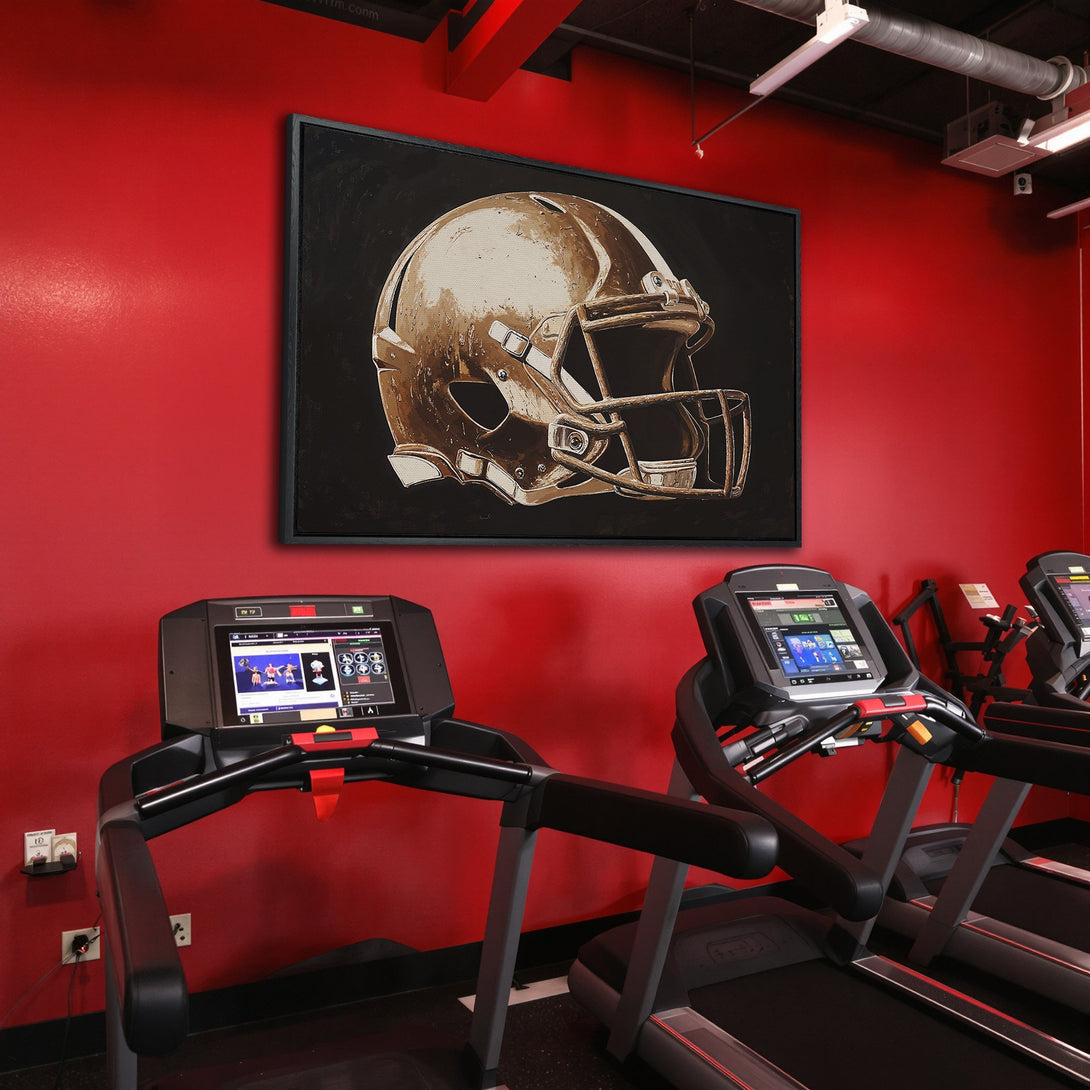 Framed Wall Art: Gold football helmet canvas print in a gym setting. Modern art with a neutral color palette against a bold red wall.