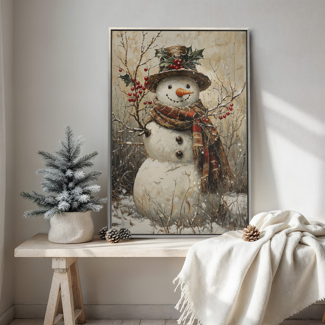 Framed Wall Art: Charming snowman painting in a rustic style. Warm neutral tones with pops of red. Perfect winter decor for your home.