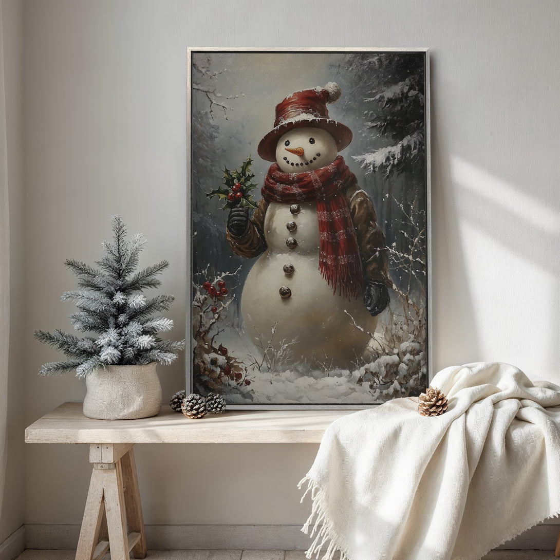 Framed Wall Art featuring a charming snowman in a winter scene. Rustic style with a warm red and neutral color palette. Perfect for cozy holiday decor.