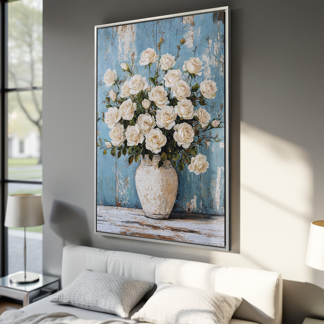 Framed Wall Art featuring a beautiful bouquet of white roses in a vase, set against a distressed blue background. Elegant floral art with a neutral color palette.
