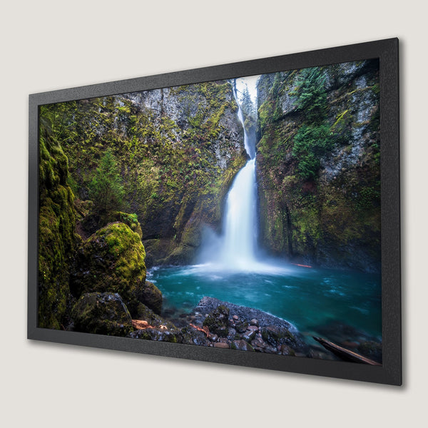 Framed Poster of a stunning waterfall landscape. Vibrant blues and greens create a tranquil nature scene. Perfect wall art!