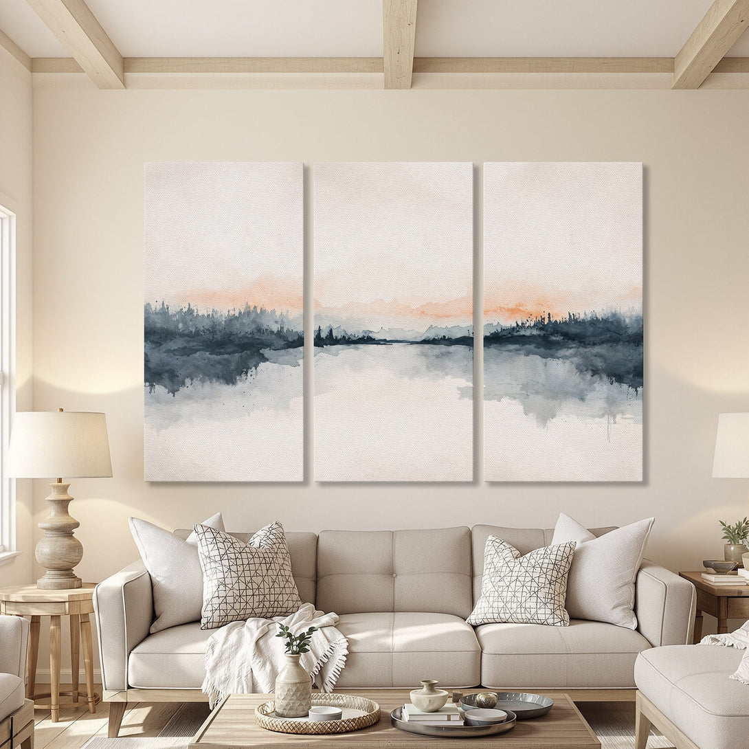 Canvas Print triptych of a watercolor landscape in a neutral living room. Features a serene lake scene with blue, gray, and orange hues. Modern wall art.