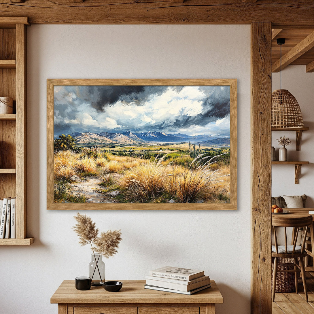 Framed Poster of a landscape painting with mountains, fields, and dramatic skies. Earthy tones and a rustic style.