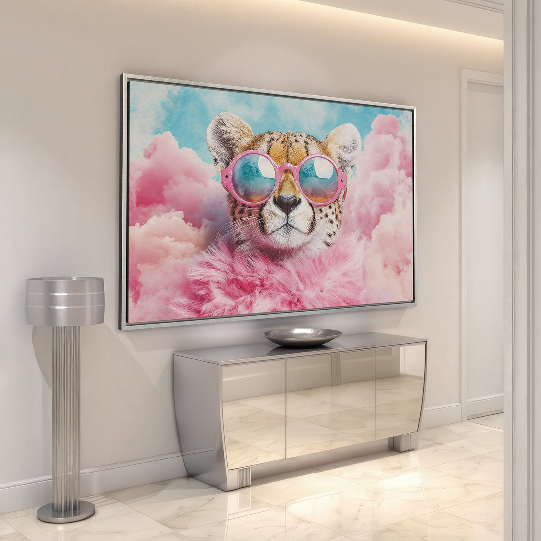 Framed Wall Art: Playful cheetah in sunglasses, set against a dreamy pink and blue cloudscape. Modern, colorful decor for a stylish interior.
