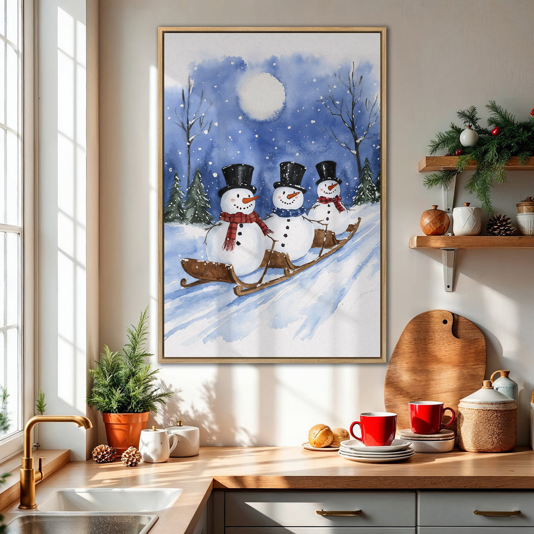 Framed Wall Art: Watercolor painting of snowmen sledding in a winter scene. Blue and white color palette, perfect for holiday decor.