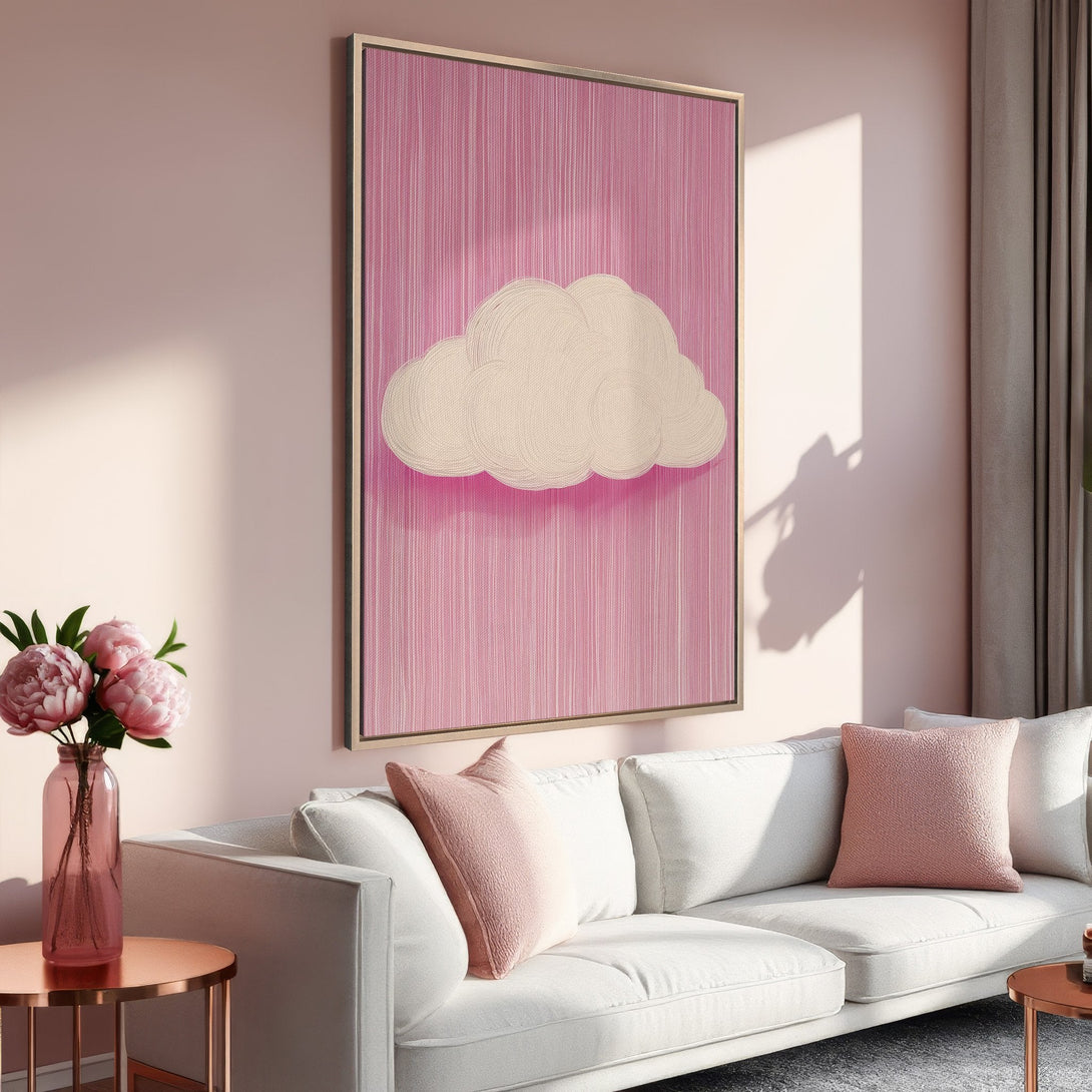 Framed Wall Art featuring a whimsical cloud on a pink background. Modern art piece in a soft, blush and cream color palette. Perfect for living room decor.