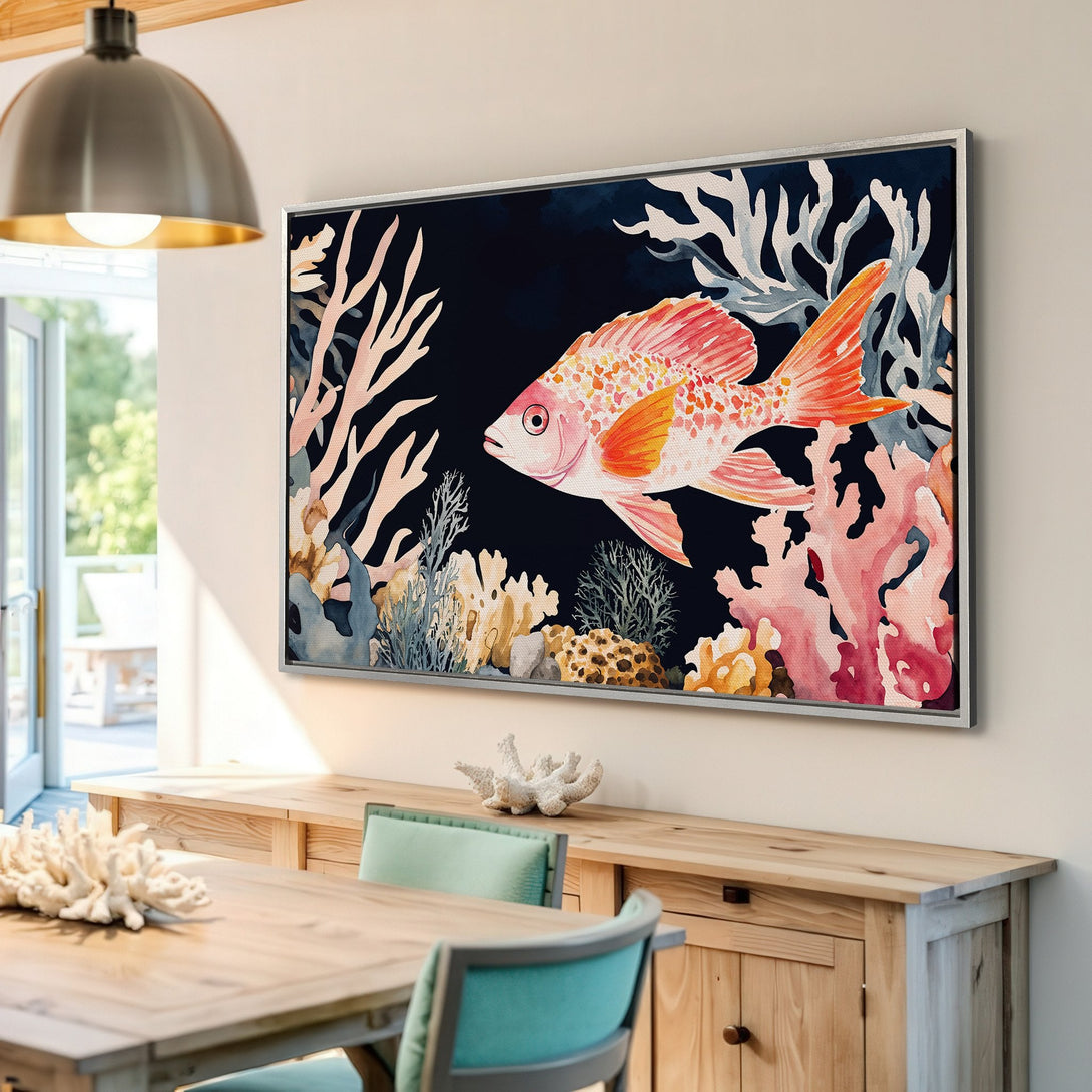 Framed Wall Art: Watercolor fish print in a coastal style, featuring coral reef elements and a vibrant orange and pink color palette. Perfect for beachy decor.