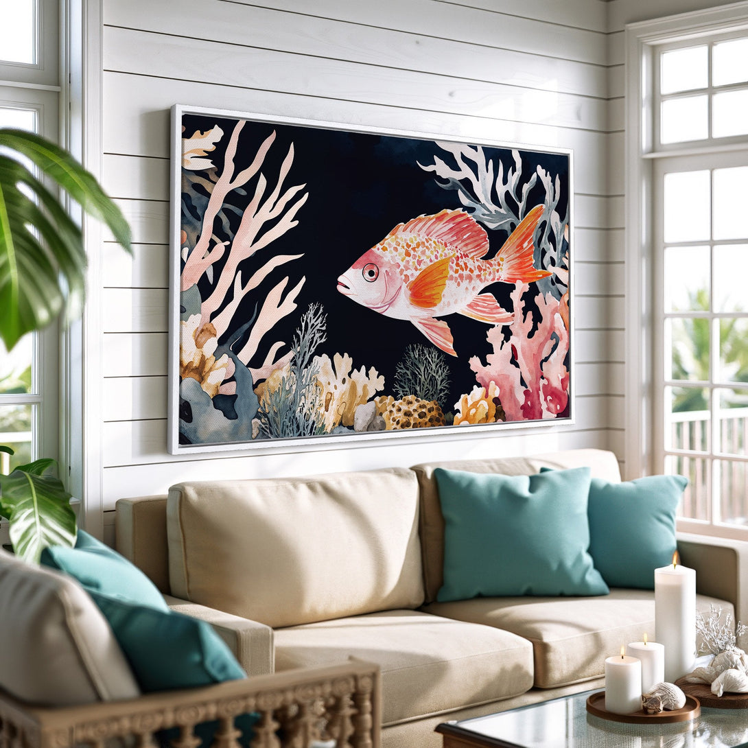 Framed Wall Art: Watercolor fish print with coral reef in a coastal living room. Featuring a vibrant red, orange, and blue color palette.