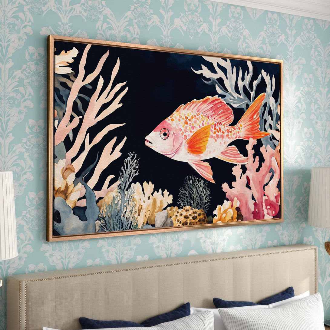 Framed Wall Art featuring a watercolor fish and coral reef in a vibrant orange and pink palette, perfect for coastal decor.