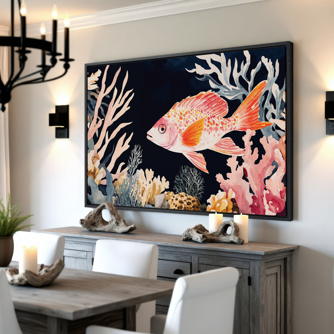 Framed Wall Art featuring a vibrant watercolor goldfish and coral reef. Adds coastal charm with a palette of coral, orange, and deep blue. Perfect for any space!