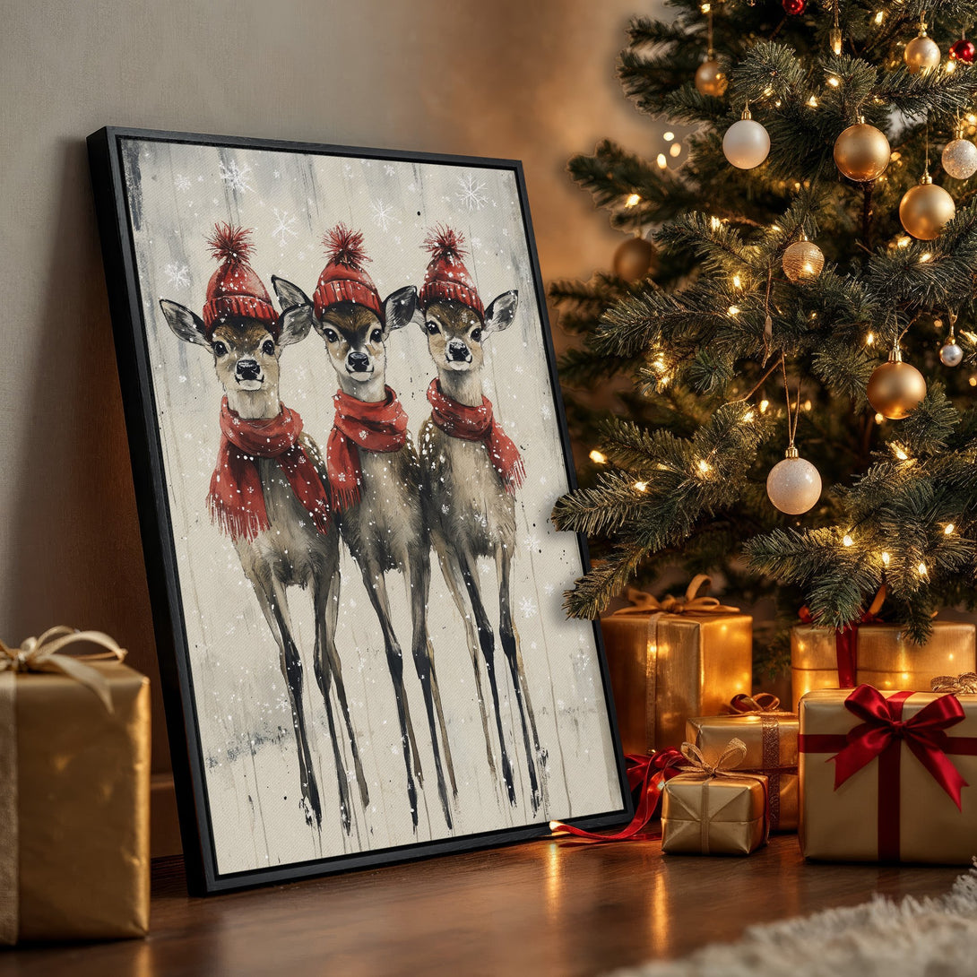 Framed Wall Art featuring adorable deer in red hats and scarves. Rustic style with a warm, neutral and red color palette, perfect for holiday decor.