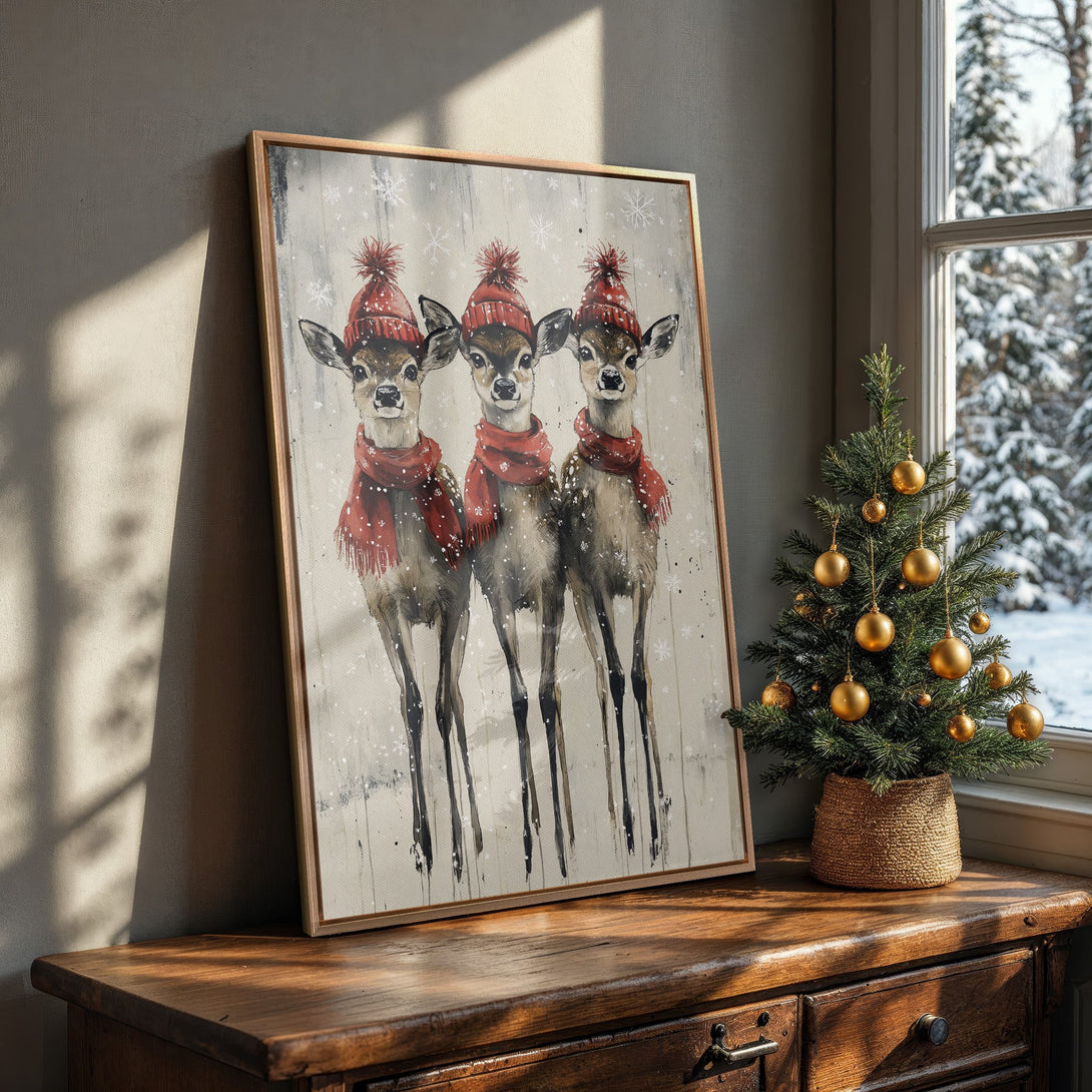 Framed Wall Art: Watercolor painting of three deer in red hats and scarves. Rustic style, neutral and red color palette, perfect for winter decor.
