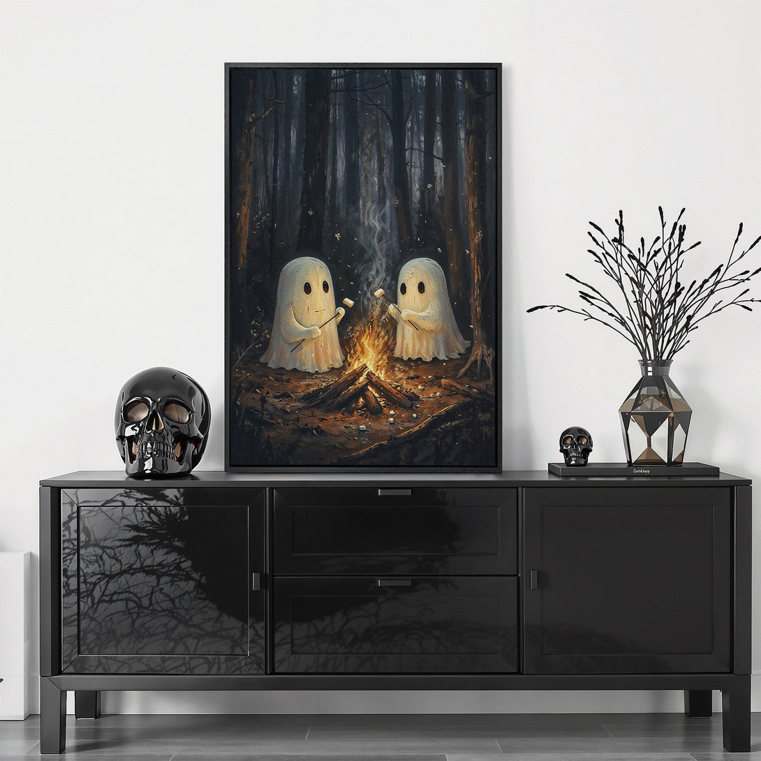 Framed Wall Art featuring two friendly ghosts roasting marshmallows by a campfire in a dark forest. Moody, whimsical art in a muted, earthy color palette.