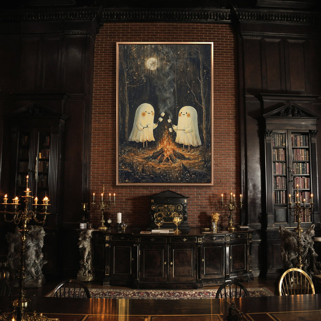 Framed Wall Art: Adorable ghost art with a campfire scene in a dark, moody interior. Warm color palette, perfect for Halloween decor.