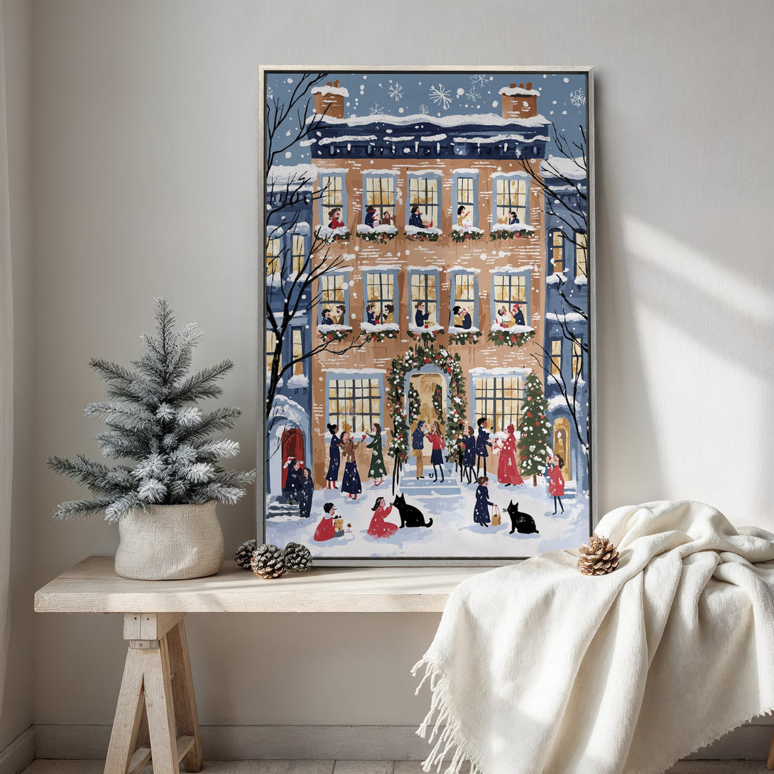 Framed Wall Art featuring a festive winter scene with a cozy illustration of a house, people, and snow. Warm, inviting color palette for holiday decor.