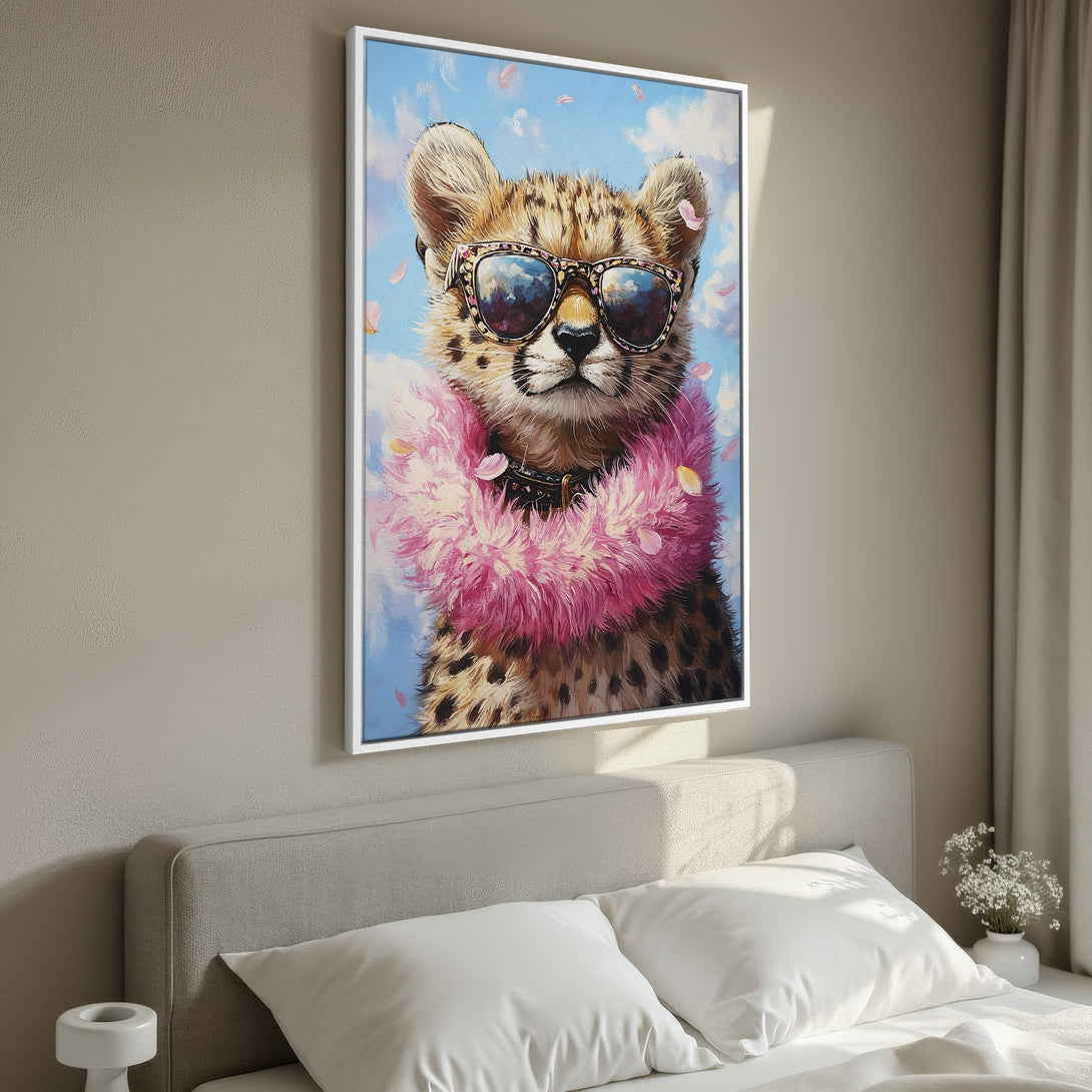 Framed Wall Art: Playful cheetah portrait in sunglasses & pink boa, displayed in a bedroom. Whimsical style with blue, pink, & neutral tones.