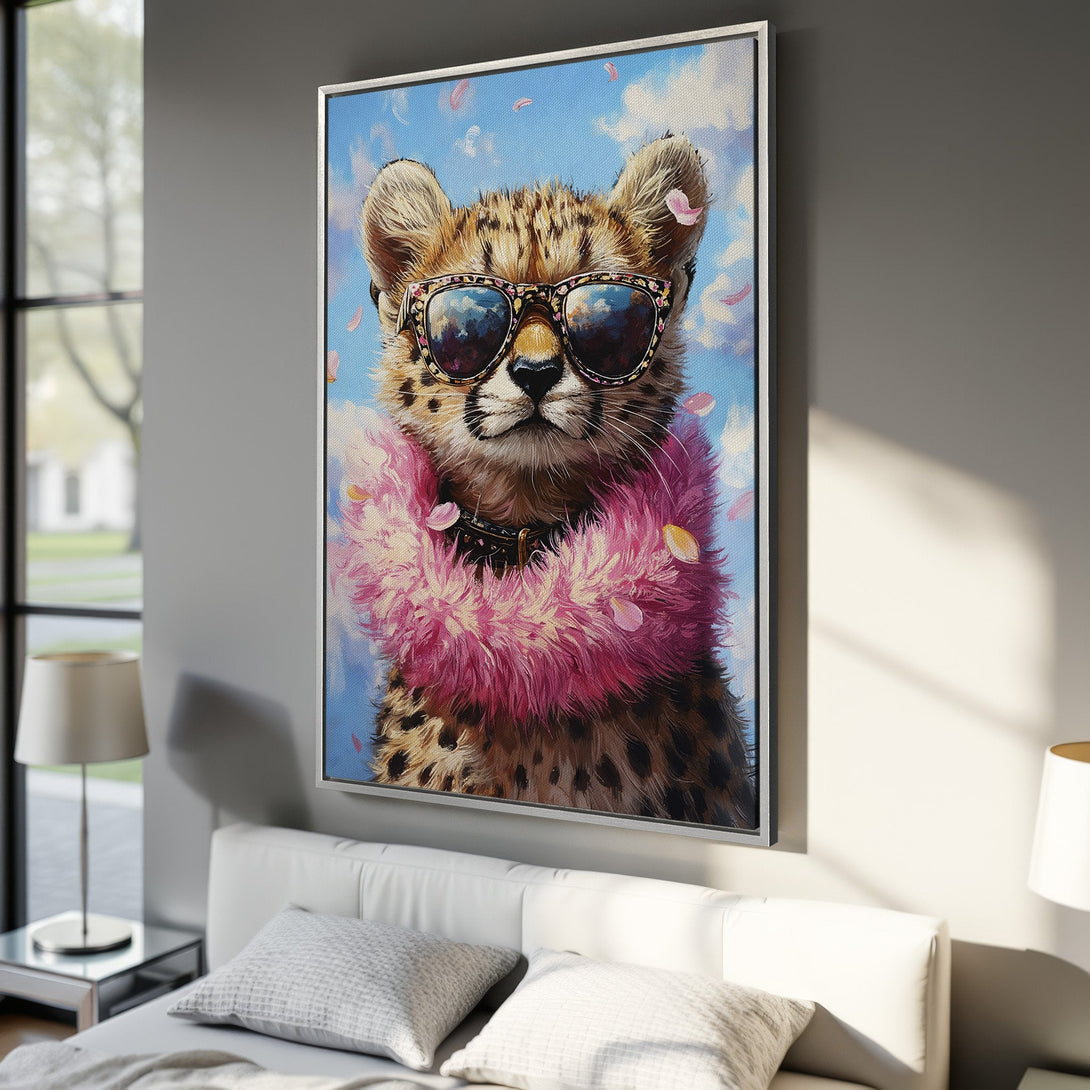 Framed Wall Art: Playful cheetah painting with sunglasses, pink boa, and blue sky background. Stylish wall decor in a vibrant color palette.