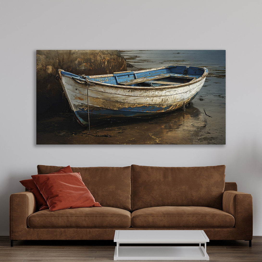 Coastal-inspired Framed Wall Art featuring an old boat in muted blues and whites. Perfect for adding a touch of serenity to your home decor.
