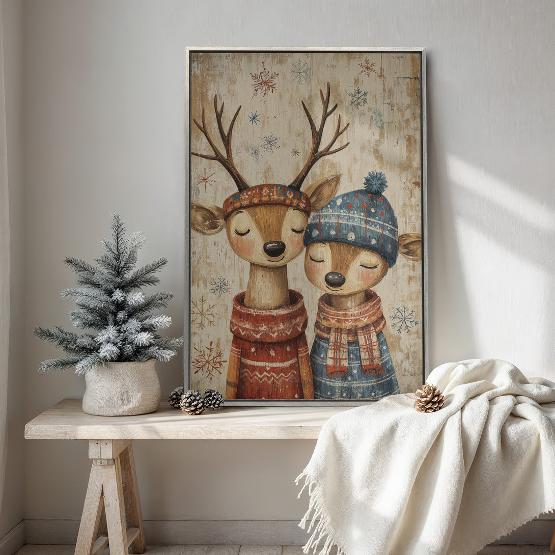 Framed Wall Art featuring adorable deer in winter attire. Warm, inviting color palette with red, blue, and brown tones. Perfect for cozy holiday decor.