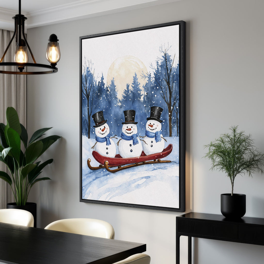 Framed Wall Art: Watercolor winter scene with snowmen on a sled, blue and white color palette. Perfect for holiday decor. Shop Canvas Prints today!