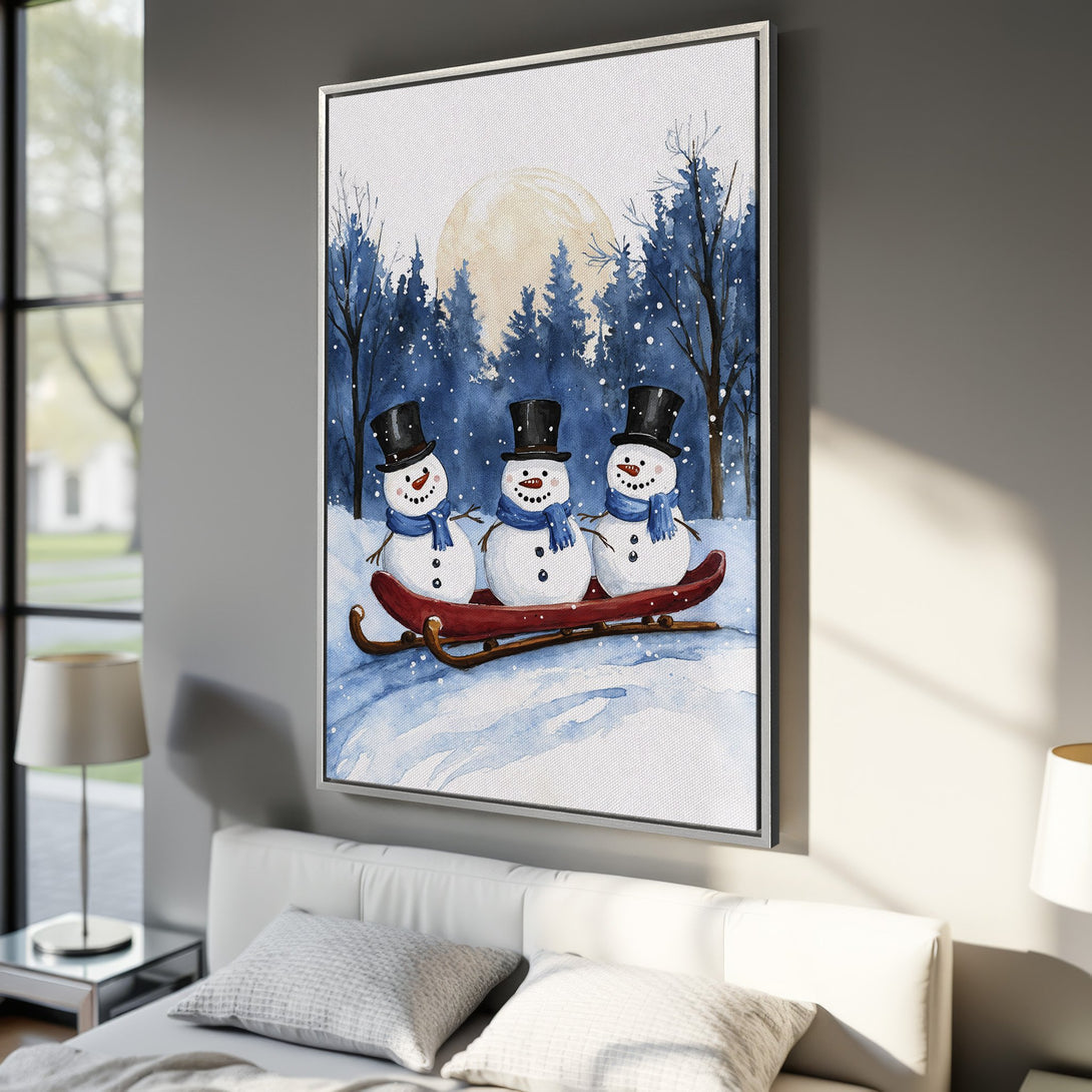 Framed Wall Art: Watercolor winter scene with snowmen on a sled. Blue and white color palette, perfect for holiday decor. Add cozy charm to your space!
