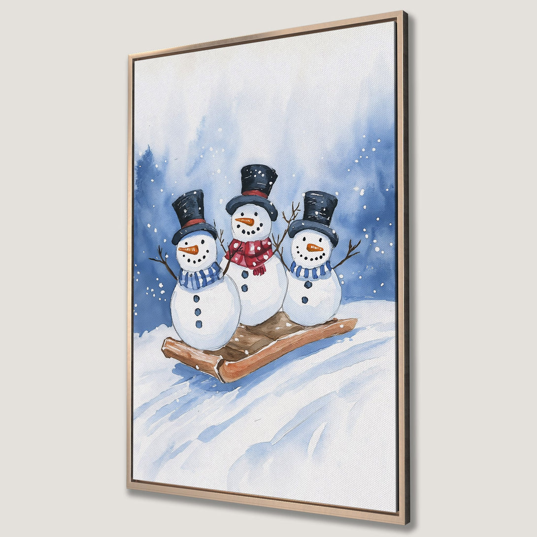 Framed Wall Art featuring a watercolor painting of three snowmen on a sled, with a blue and white winter color palette. Perfect holiday decor!