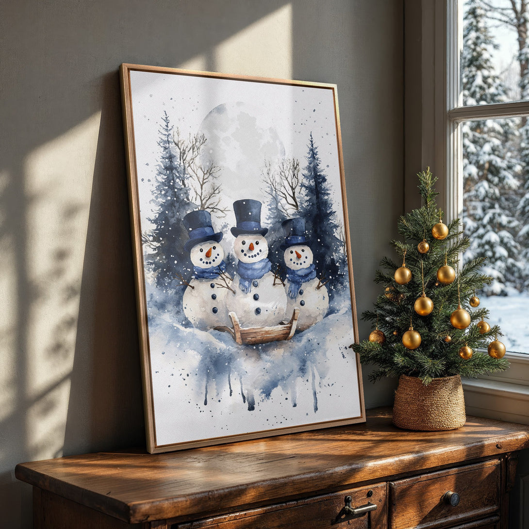 Framed Wall Art featuring watercolor snowmen in a winter scene. Blue and white color palette. Perfect holiday decor for a cozy home.