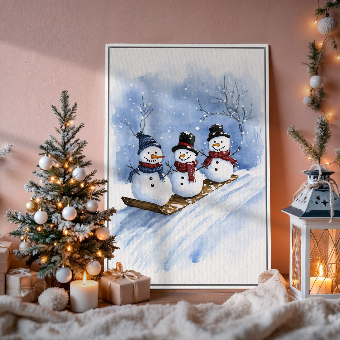 Framed Wall Art: Watercolor snowmen scene in blue and white, perfect for winter decor. Cozy holiday vibes in a warm interior setting.