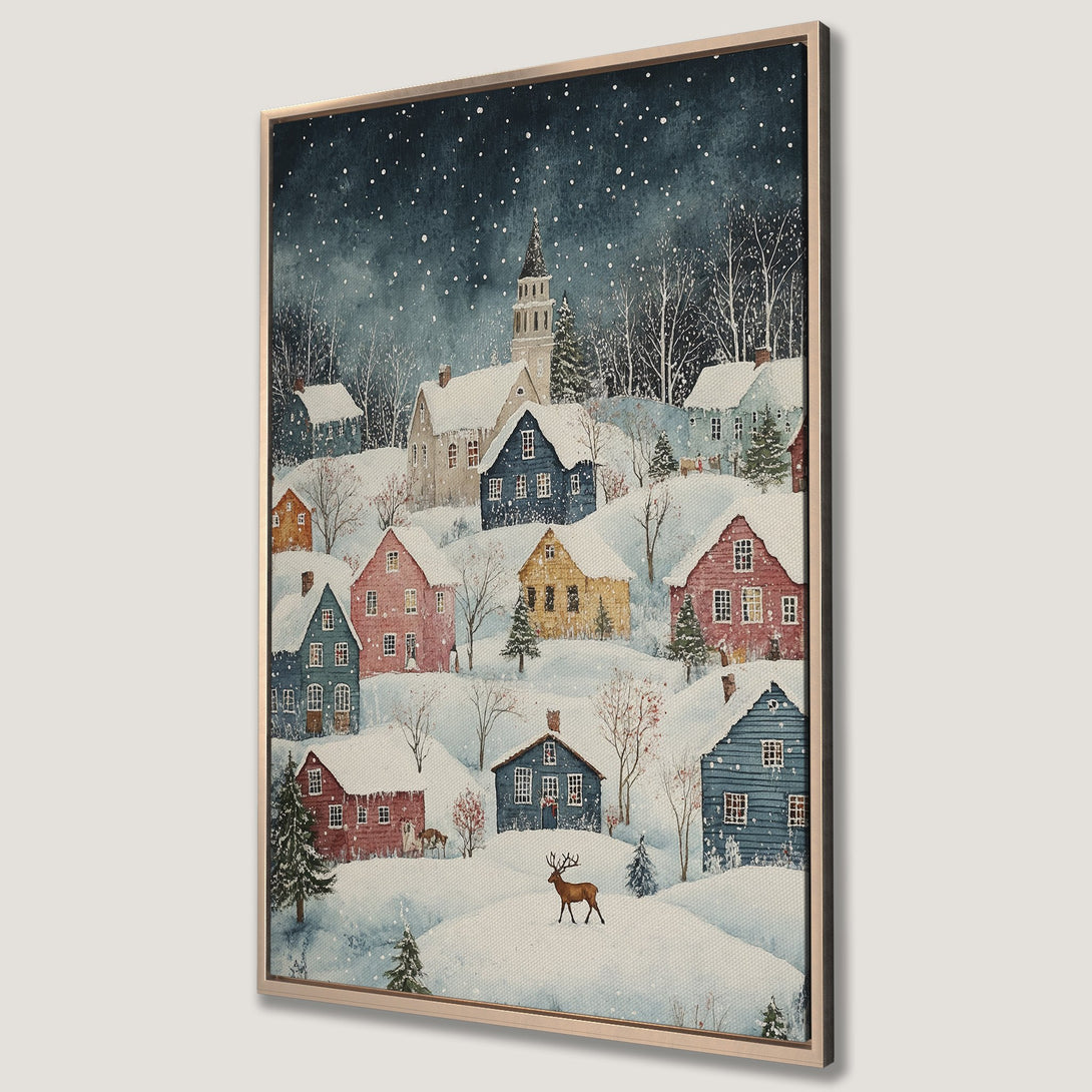 Framed Wall Art featuring a charming winter village scene with colorful houses and a deer. Watercolor style art with a serene, snowy landscape and a calming blue and pastel color palette.