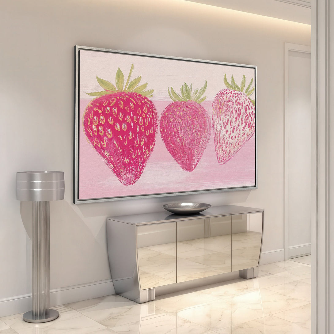 Framed Wall Art featuring three vibrant strawberries. Modern, colorful artwork with a pink and red palette, perfect for adding a pop of style to your home.