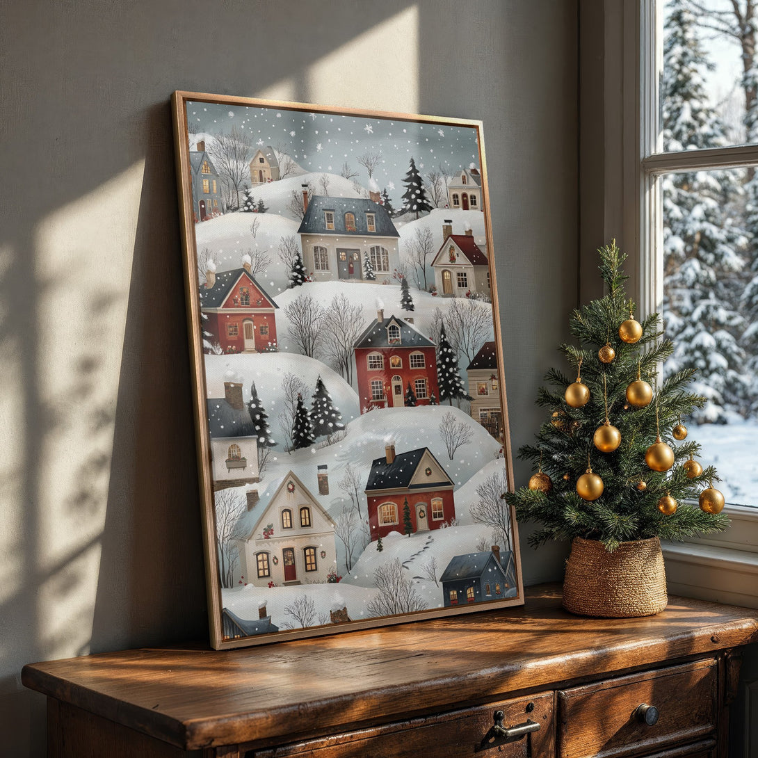 Framed Wall Art featuring a charming winter village scene in a warm, inviting color palette. Perfect for adding cozy holiday decor to your home.