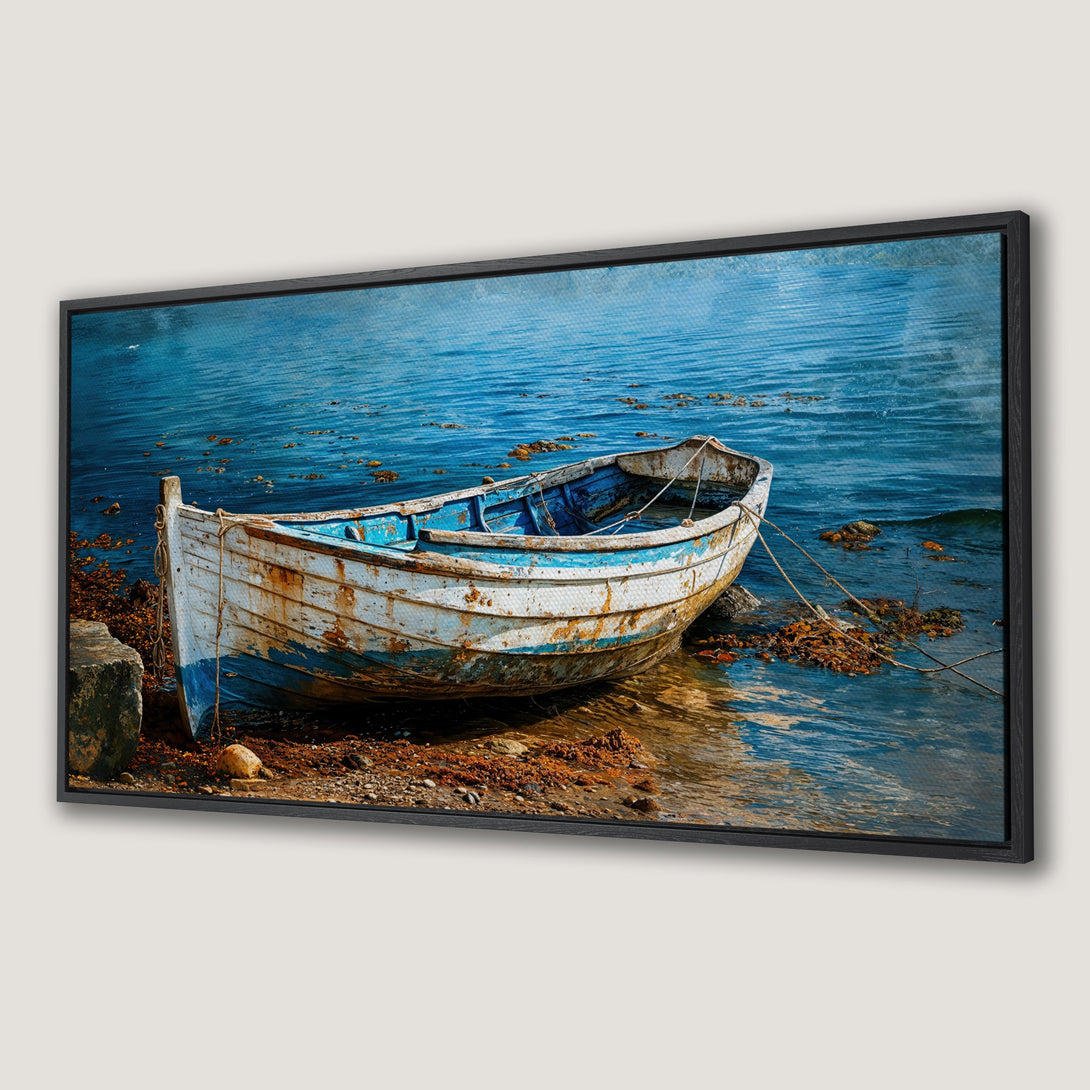 Framed Wall Art: Rustic boat on shore, blue and white palette, inspired by the sea. Coastal decor for a relaxing vibe.