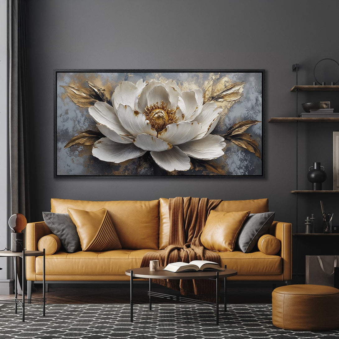 Framed Wall Art: Stunning white flower canvas print with gold accents, displayed in a modern living room with a warm, neutral color palette.
