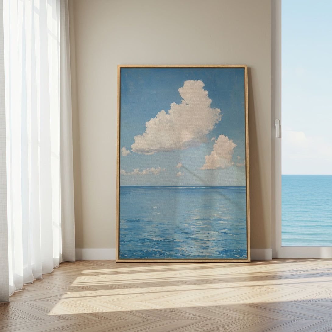 Framed Wall Art featuring a serene seascape with clouds, in a calming blue and white color palette. Perfect for coastal decor.