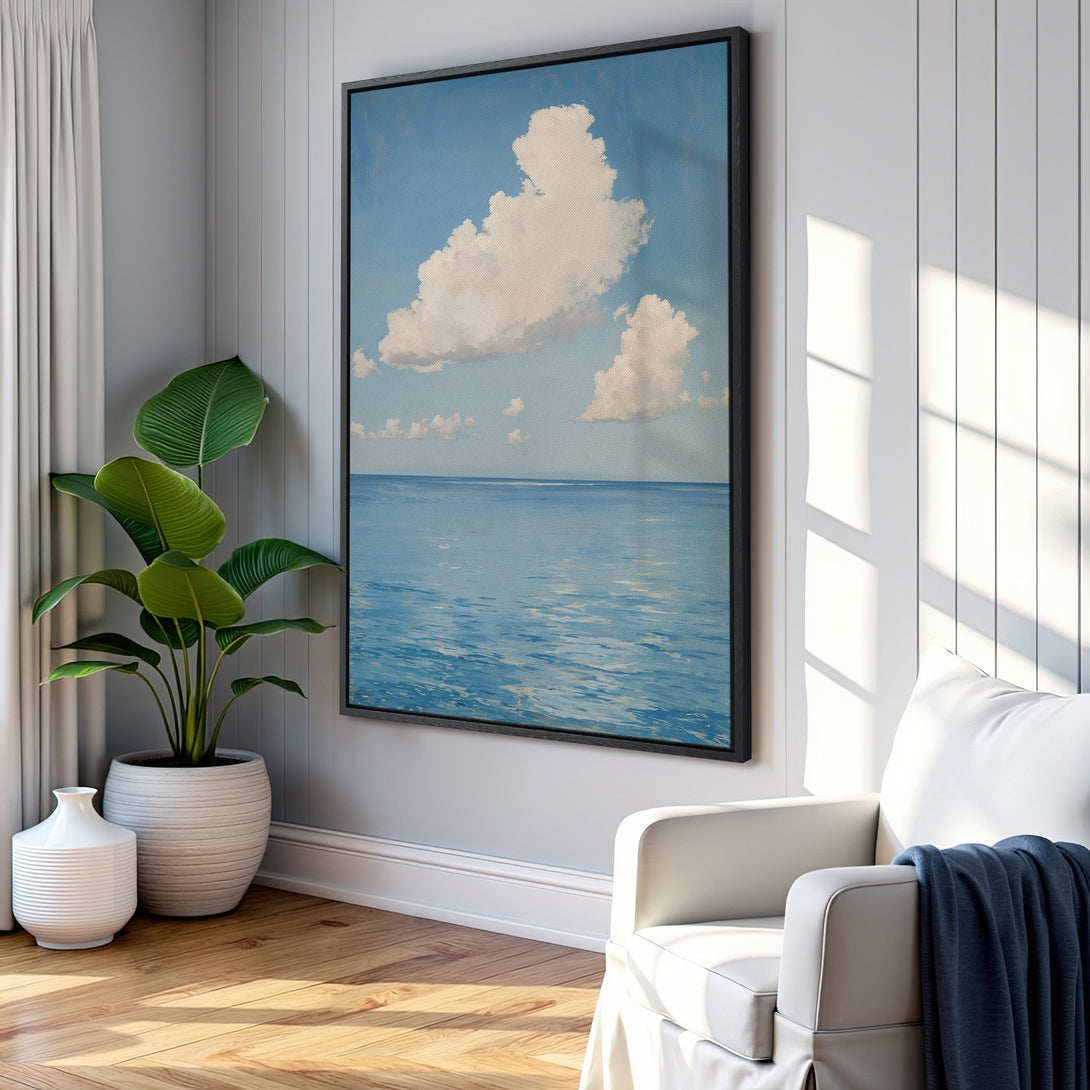 Framed Wall Art of serene ocean and clouds, blue and white palette, displayed in a modern interior. Perfect for coastal decor!