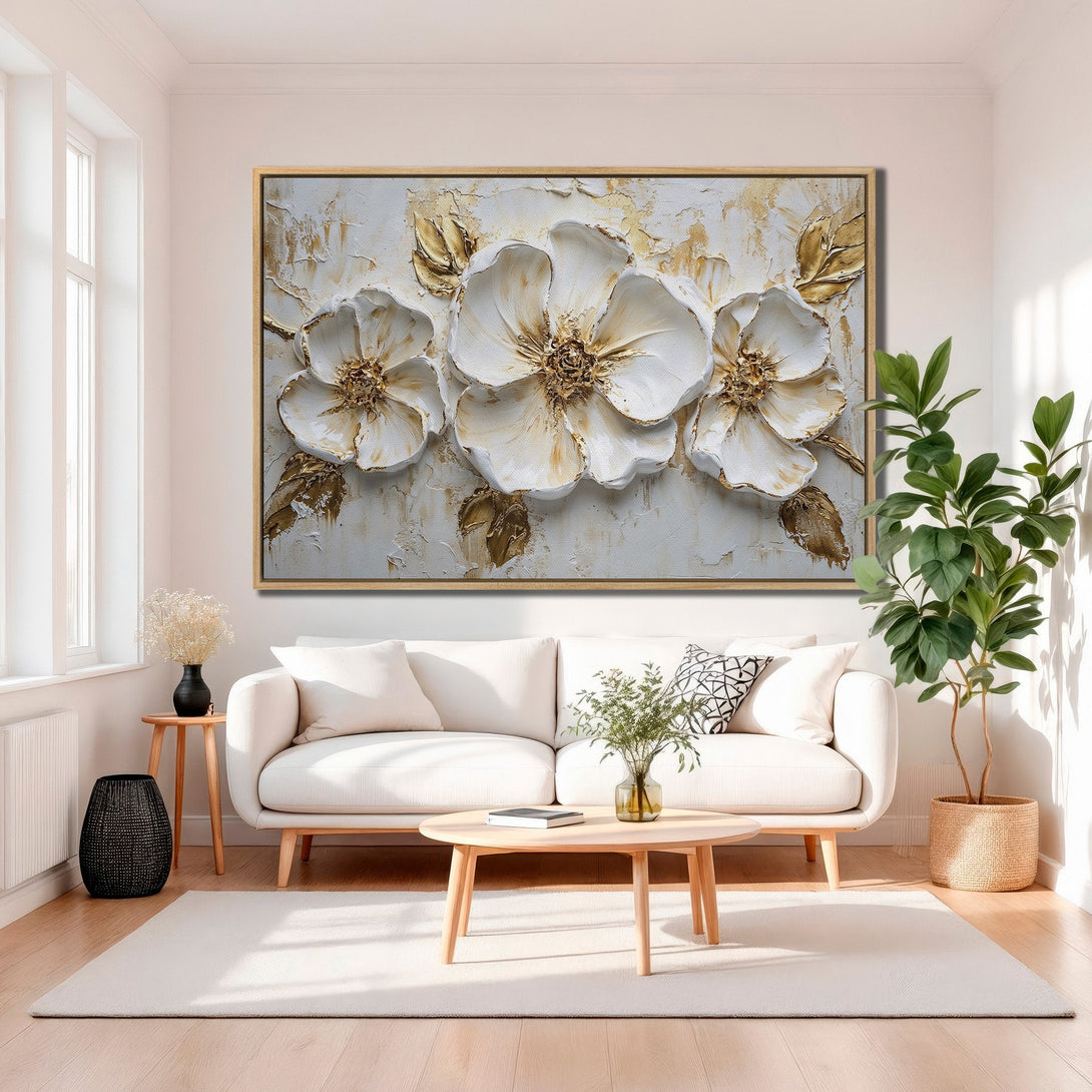 Framed Wall Art featuring textured white and gold floral design, perfect for adding elegance to any living room. Neutral color palette.