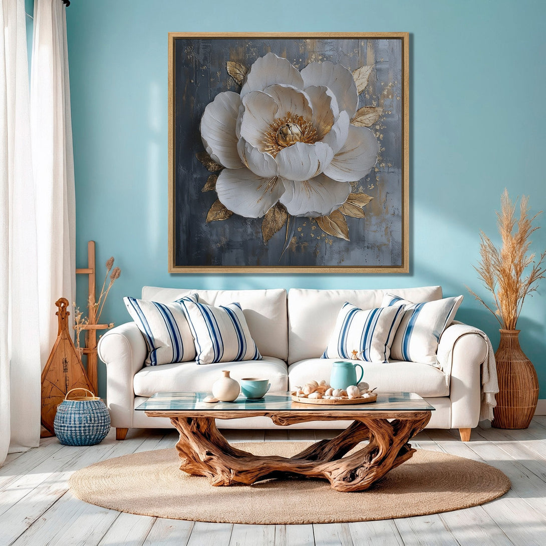 Framed Wall Art: Stunning floral canvas print in a modern, coastal living room. Features a white and gold flower on a gray background, complementing the blue and neutral tones.