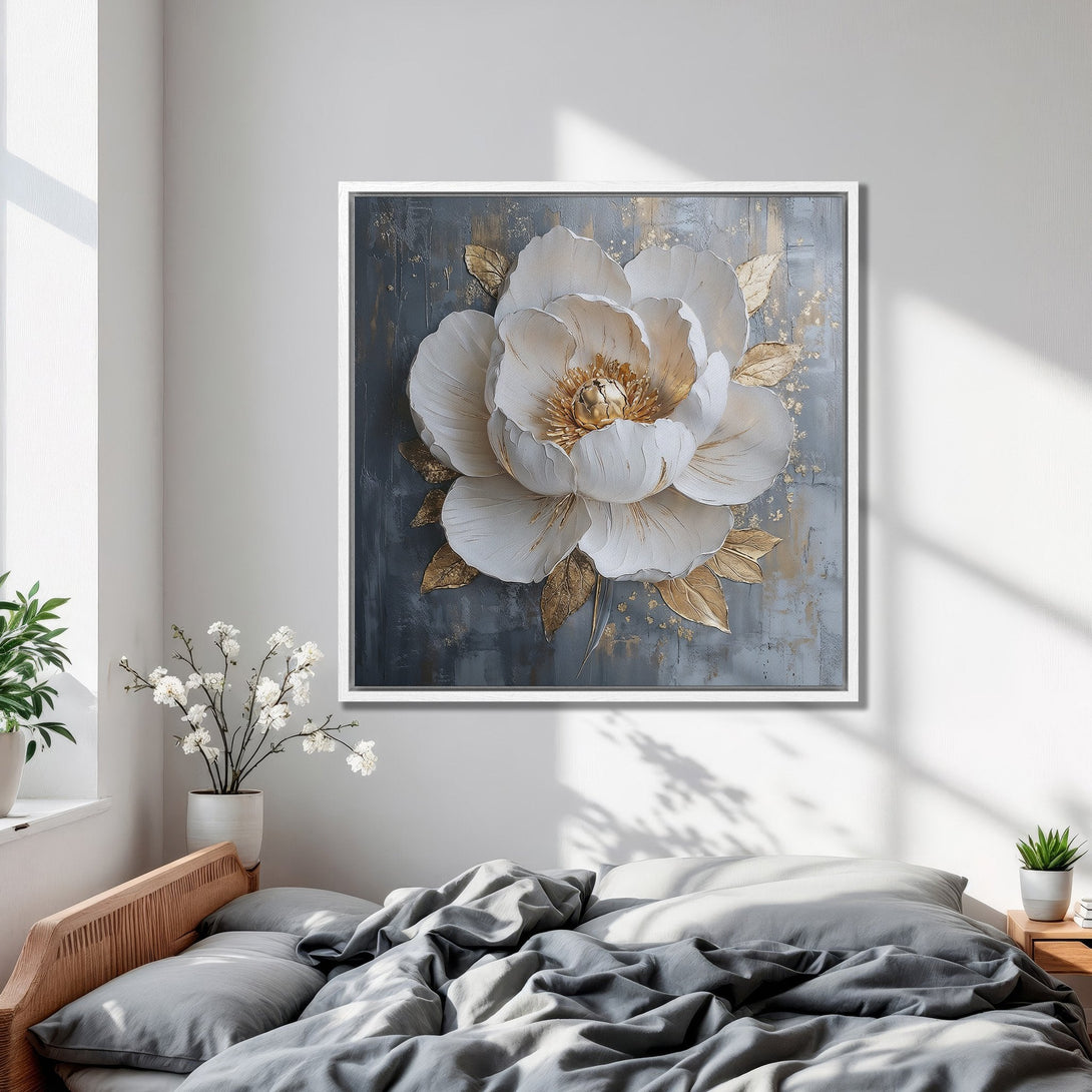 Framed Wall Art: Elegant white and gold floral canvas print in a modern bedroom. Neutral gray and gold color palette, perfect for home decor.