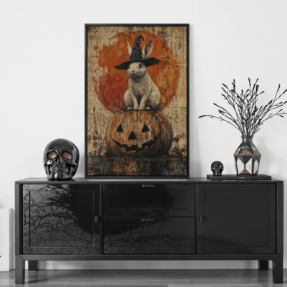 Framed Wall Art: Whimsical Halloween bunny in a witch hat on a pumpkin, rustic style, warm orange & brown palette. Perfect for spooky season decor!