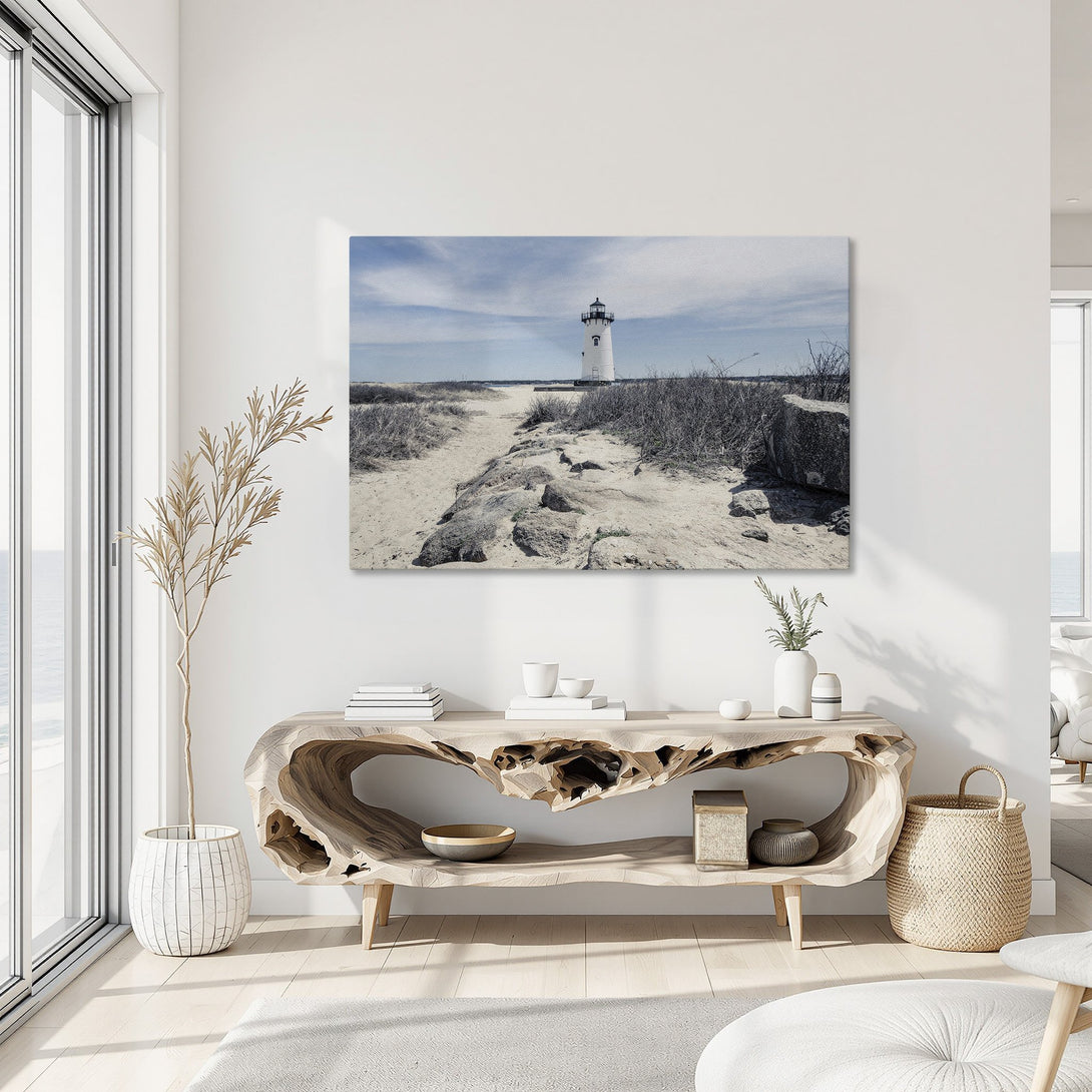 Framed Wall Art: Lighthouse on canvas print in neutral tones. Coastal decor with blue sky and sandy path. Perfect for living room or bedroom.